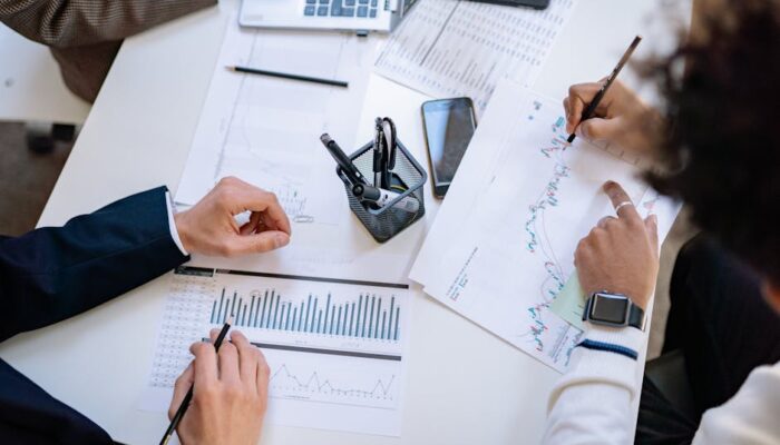 Business team analyzing financial charts and graphs during a collaborative meeting. - Photo by Yan Krukau on Pexels