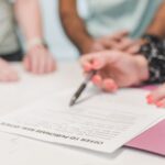 Close-up of people reviewing and signing an offer to purchase real estate document. - Photo by RDNE Stock project on Pexels