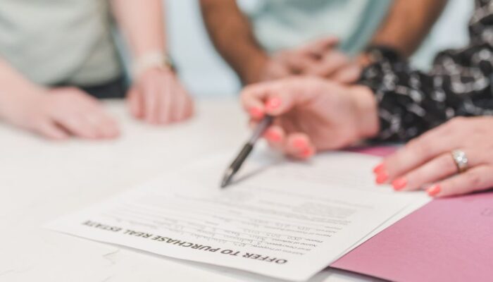 Close-up of people reviewing and signing an offer to purchase real estate document. - Photo by RDNE Stock project on Pexels