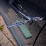 Close-up of a locksmith tool inserted into a car door lock, demonstrating security access. - Photo by My Car Key Hero on Pexels