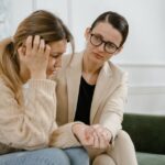 A woman receives counseling from a professional, showcasing empathy and mental health support. - Photo by MART PRODUCTION on Pexels