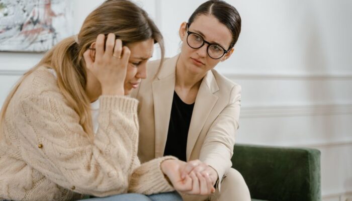 A woman receives counseling from a professional, showcasing empathy and mental health support. - Photo by MART PRODUCTION on Pexels