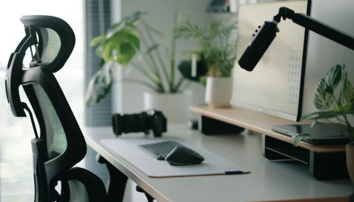Stylish home office setup with ergonomic chair, plants, and tech accessories creating a modern work environment. - Photo by Alpha En on Pexels